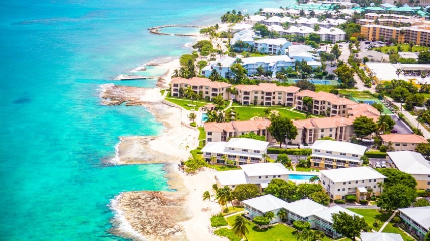 A Caribbean paradise turned financial powerhouse — the Cayman Islands thrive on finance, tourism, and real estate, offering no income tax and a high $87,000 PPP per capita amid soaring living costs