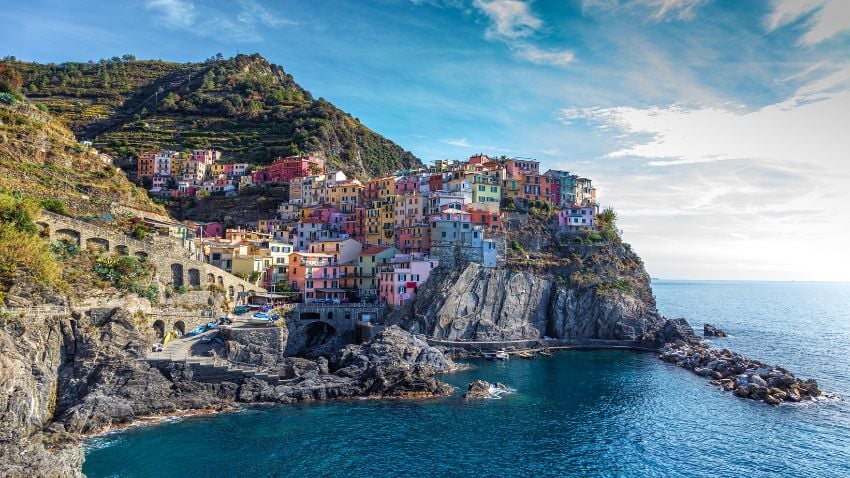 Cinque Terre charms with pastel cliffside villages, scenic coastal trails, and sweeping Mediterranean views, a UNESCO treasure where beauty, history, and nature meet