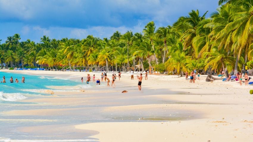Expat relaxing with family on a beach in the Dominican Republic - The Dominican Republic offers an enticing opportunity for individuals seeking residency through investment, a program that provides access to a life in one of the Caribbean's most vibrant countries. This program is tailored for investors and their family members, allowing them to obtain a residence permit by meeting specific qualifications and investing in the country's economy. The process involves adherence to a set of regulations set by the Dominican government, ensuring transparency and legality in all proceedings. Potential investors are required to contribute capital to government-approved projects or deposit funds in local banks. This investment not only secures a residence permit but also opens doors to numerous benefits, including access to the Dominican banking system and potential tax advantages.