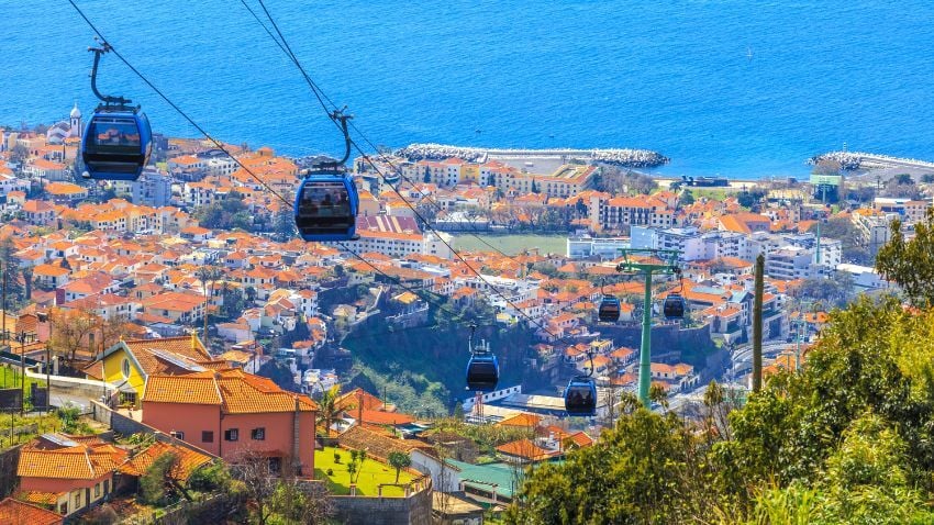 The cable cars over Funchal reveal one of the best places to visit in Portugal for panoramic island perspectives. Madeira is a volcanic island around 1,000 kilometres southwest of Lisbon, sitting in the Atlantic closer to Morocco than to mainland Portugal