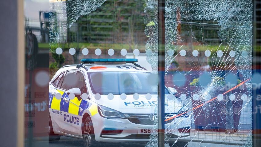 Broken glass, a police car, and a fractured society. The UK battles rising crime, riots, and eroding freedoms, leaving citizens unprotected and silenced