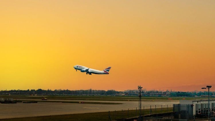 An aeroplane takes off at sunset, symbolizing the opportunity to build a new life abroad as Europe’s economic and political crises deepen.