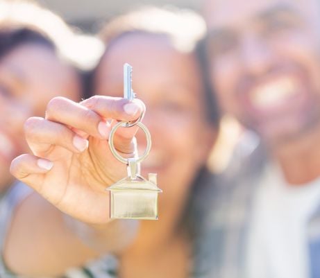 a family holding a key to their new home
