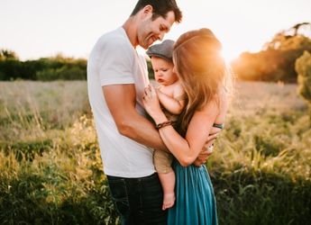 husband-wife-and-baby-hugging-on-a-sunset-1