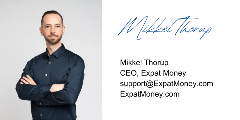 Mikkel Thorup with arms crossed, signature on the side, professional branding photo for Expat Money.