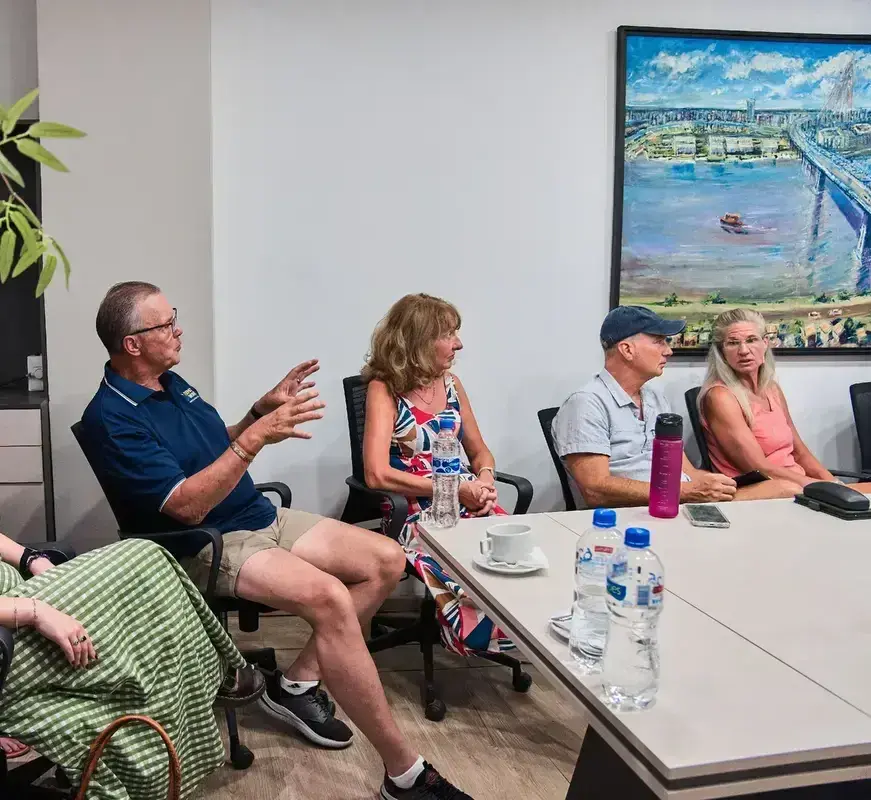 Group of clients gathered in the meeting room, talking