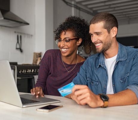 A very happy couple checking their account