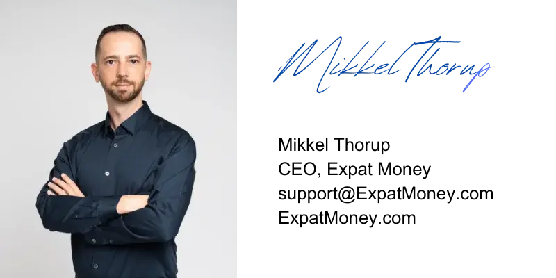 Mikkel Thorup with arms crossed, signature on the side, professional branding photo for Expat Money.
